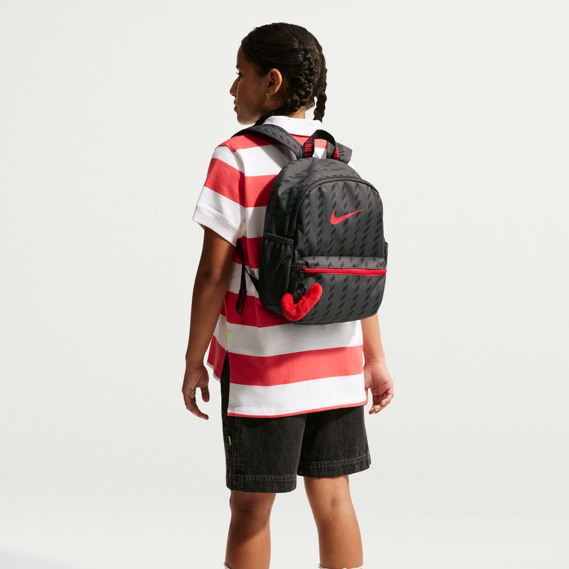 Mini black backpack on model with red zipper stripe and Nike swoosh