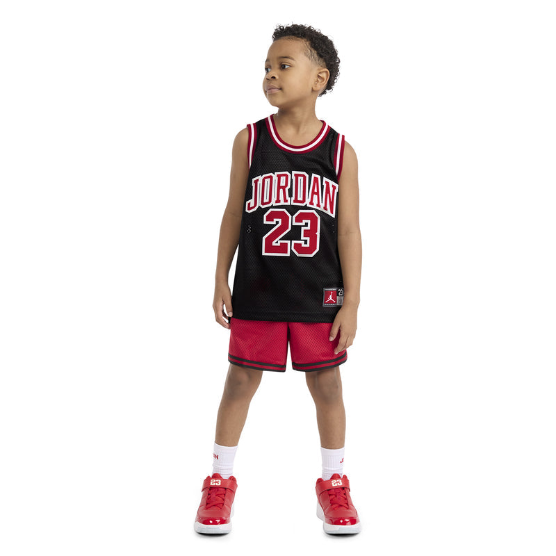 Kids black basketball jersey with 'JORDAN 23' front graphic and red trim