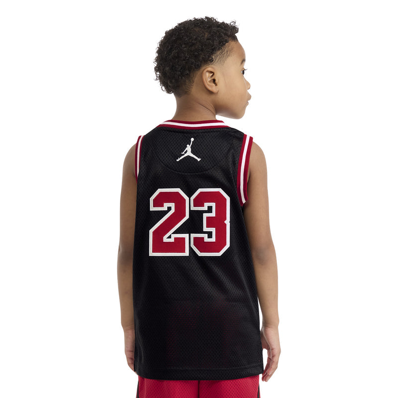 Kids black basketball jersey with '23' back print and Jumpman logo, red-and-white trim