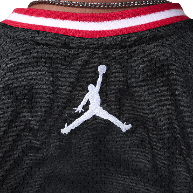 Black jersey collar with red-and-white striped trim and white Jumpman logo