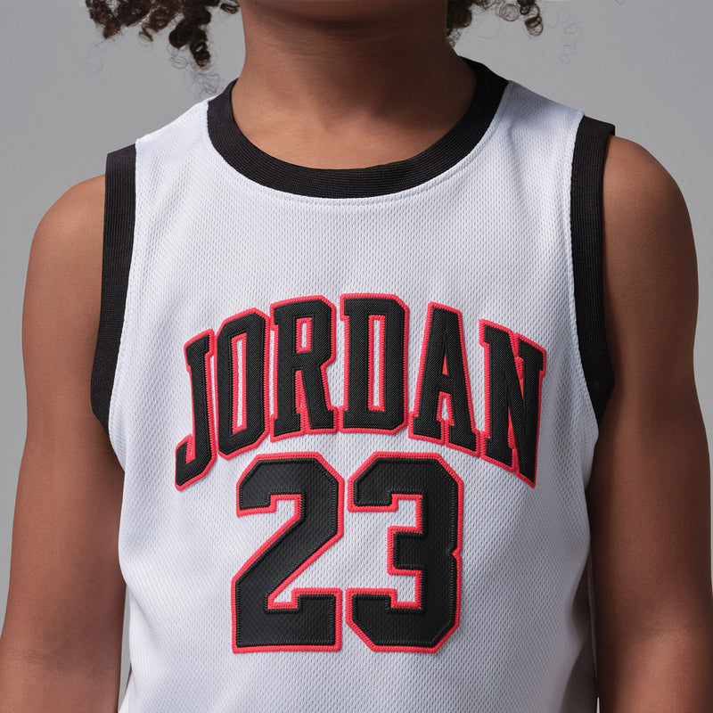 Kids white basketball jersey with black trim and red Jordan 23 front print.