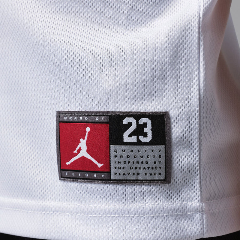 Kids jersey brand patch: red-and-black Jordan logo and 23 on white fabric.