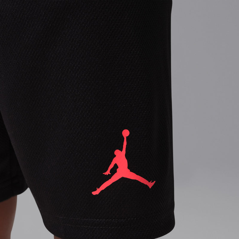 Black kids basketball shorts with red Jumpman logo at hem.