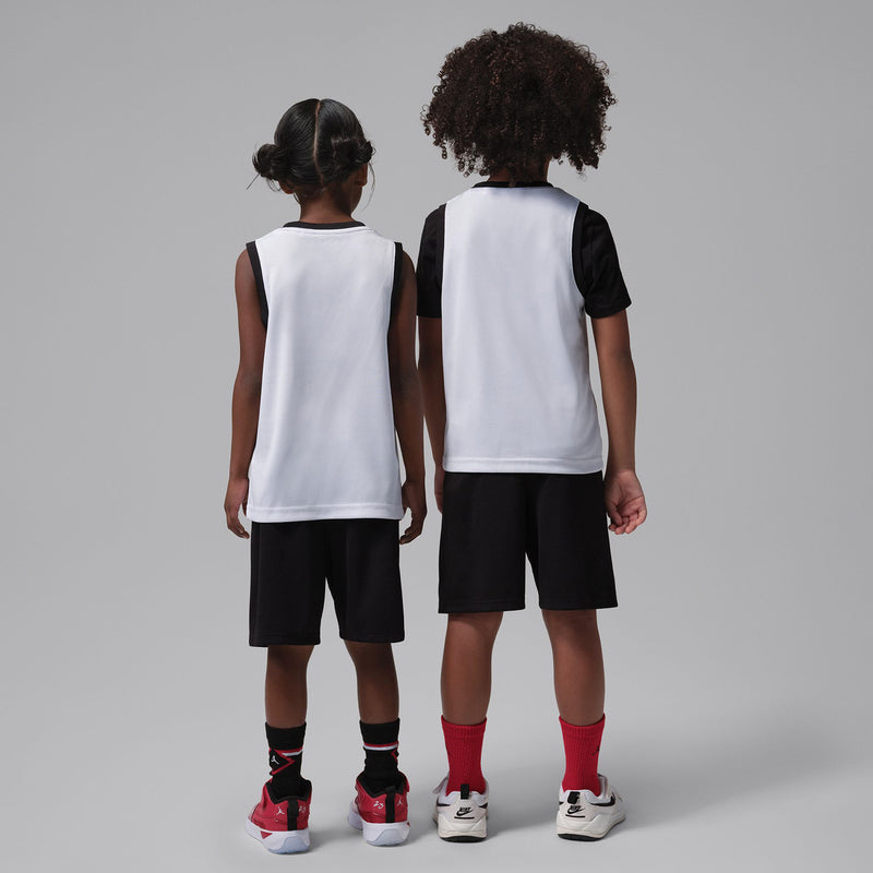 Kids basketball jersey and shorts set, back view: white tops, black shorts with red accents.