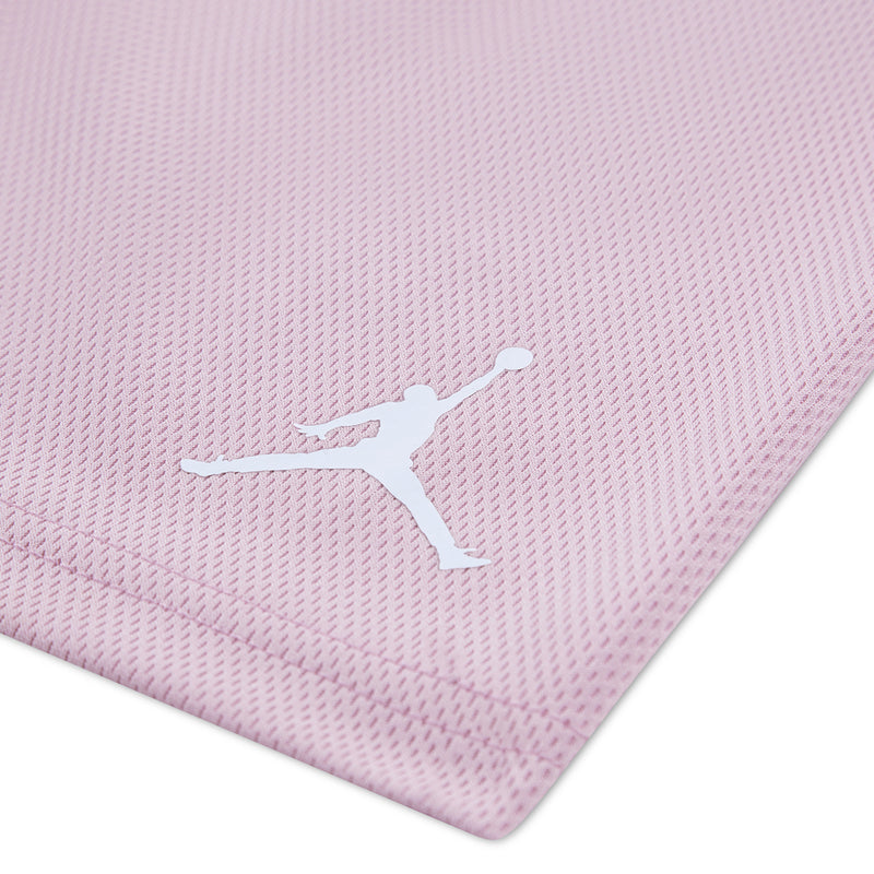 Light pink toddler shorts with white Jumpman logo on textured fabric