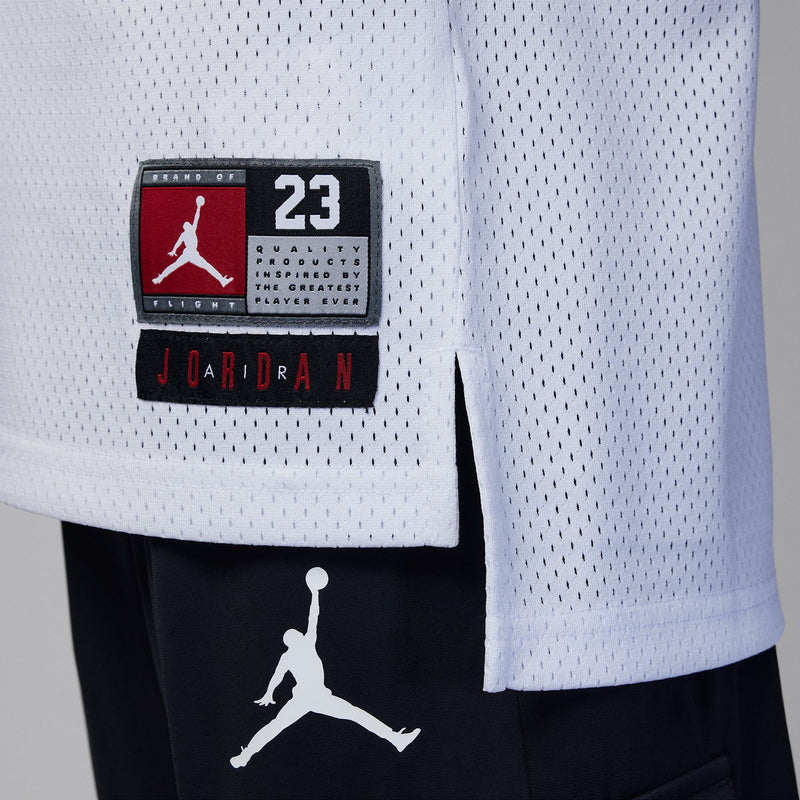White youth basketball jersey with Jordan 23 patch and Jumpman logo, light blue trim