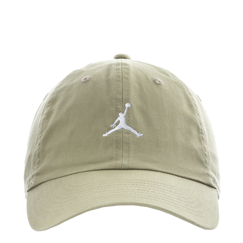 Unstructured washed khaki baseball cap with white Jumpman logo and curved brim.