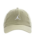 Unstructured washed khaki baseball cap with white Jumpman logo and curved brim.