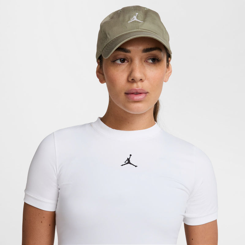 Unstructured washed khaki cap with curved brim and white Jumpman logo, worn.