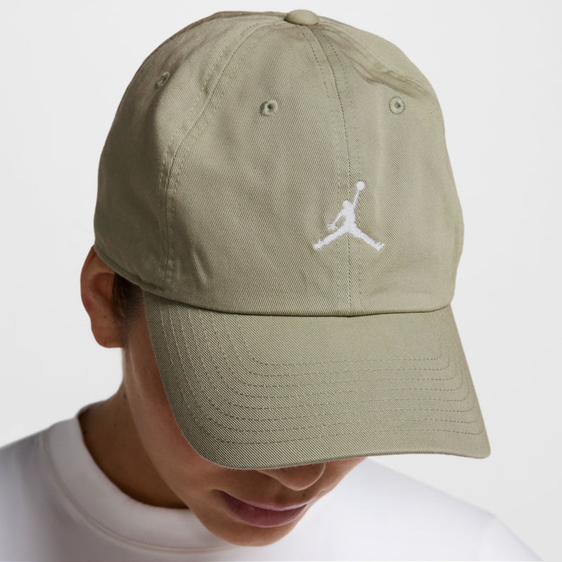 Washed khaki unstructured cap with white Jumpman on side and curved brim.
