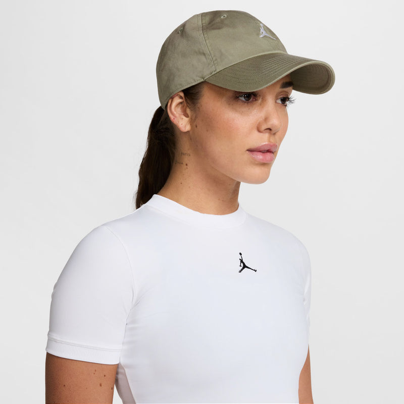 Washed khaki unstructured cap with curved brim and small white Jumpman logo on front.