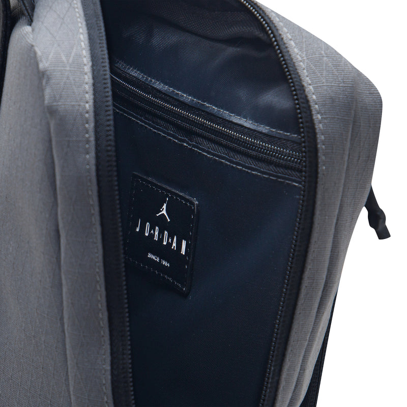 Iron grey crossbody bag with black interior zip pocket and Jordan patch logo