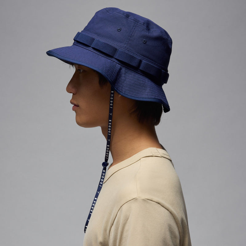Jordan Jumpman navy bucket hat with white logo, side view, chin cord trailing
