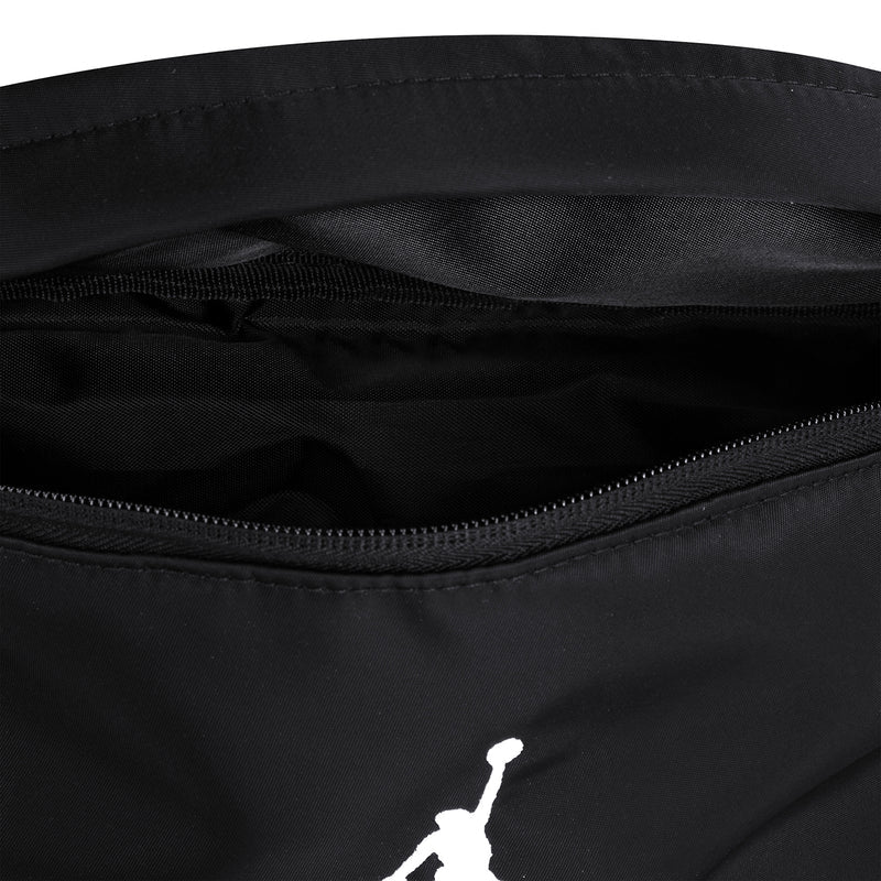Black crossbody waist bag front with visible interior pocket and black zipper