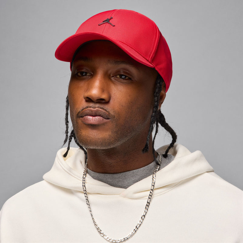 Red structured curved-bill cap with embroidered Jumpman logo, model wearing