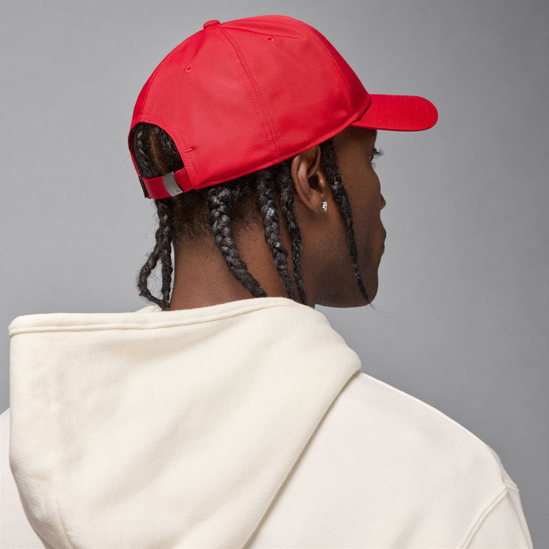 Red curved-bill cap, rear view with stitched panels