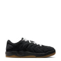 Black men’s sneakers with white laces and gum outsole, low-top lace-up style