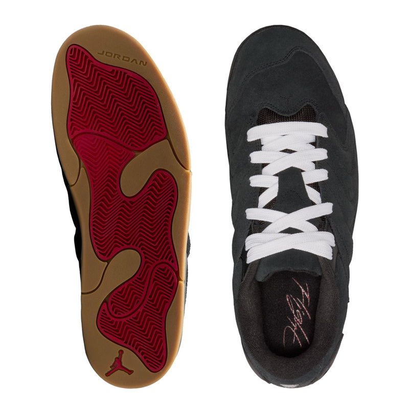 Black sneakers: red patterned outsole bottom and black upper with white laces