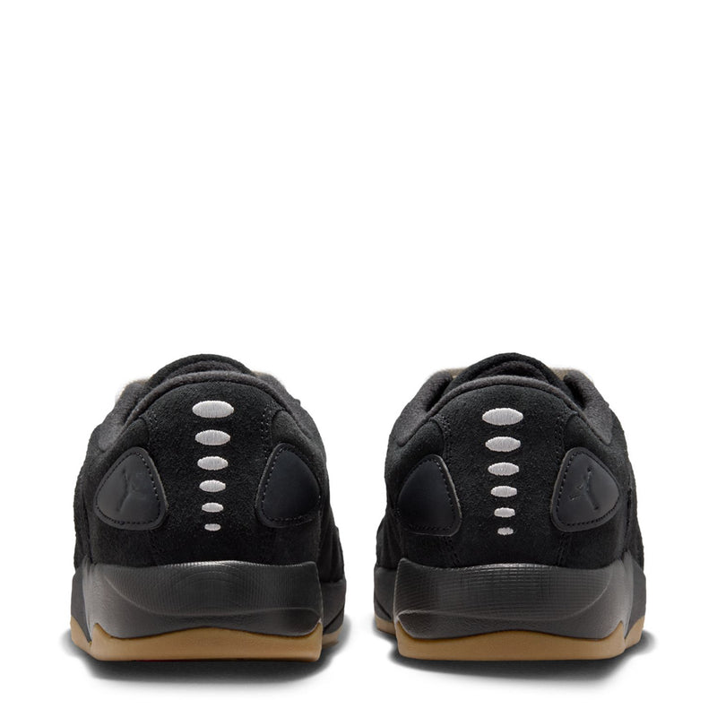 Back view of black sneakers with white lace eyelets and gum-tinted outsole