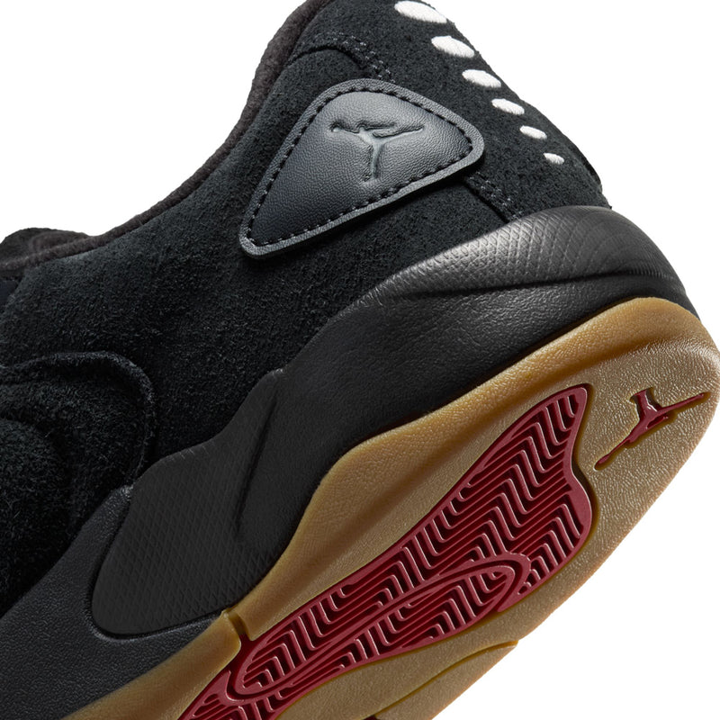 Close-up of black sneaker outsole with red patterning and Jordan logo detail