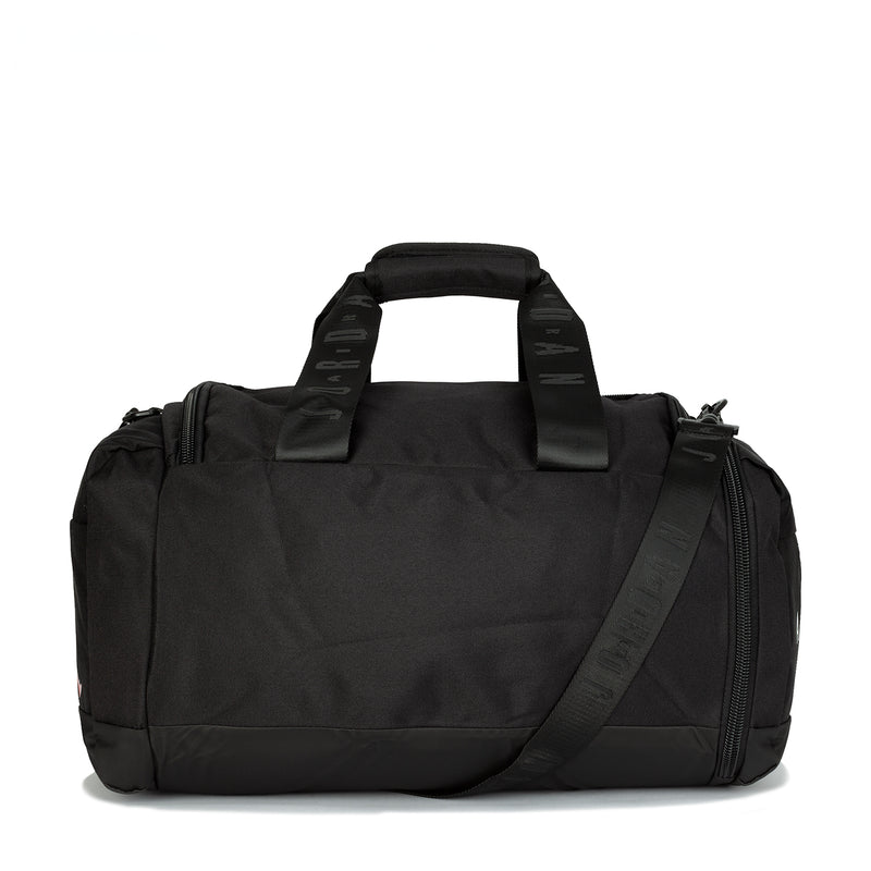 Black small duffel bag with padded top handles, side zipper pocket and strap
