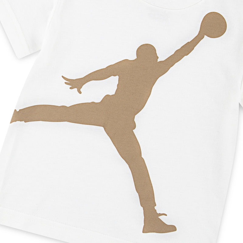 Toddler white T-shirt with large tan Jumpman graphic and tan shorts (partial view)