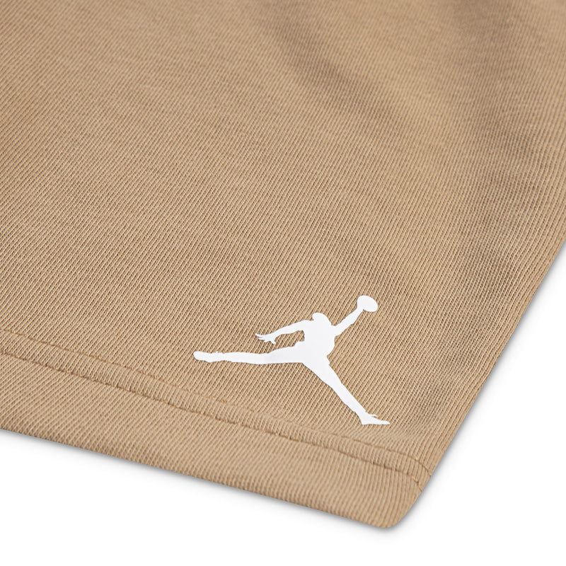 Tan knit shorts with small white Jumpman logo near hem, elastic waistband