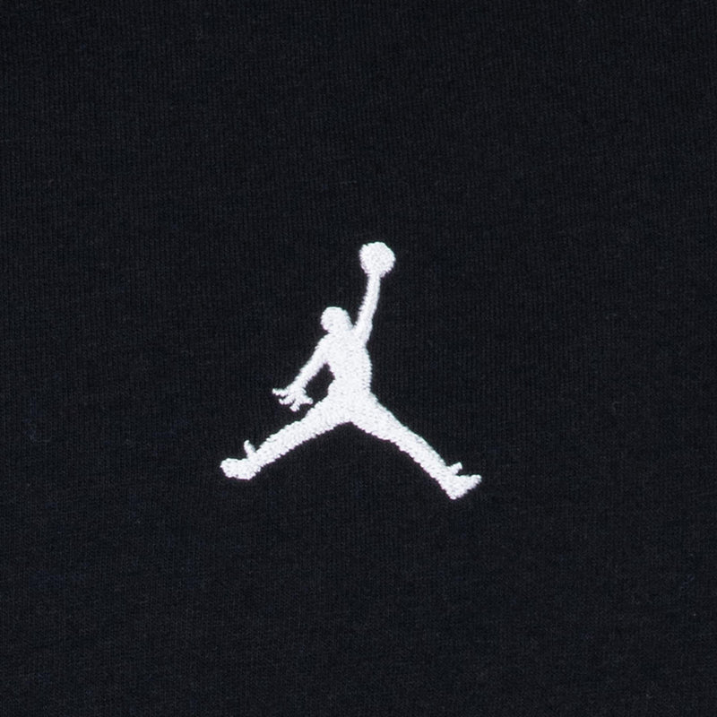 Close-up of white Jumpman embroidered logo on black youth t-shirt