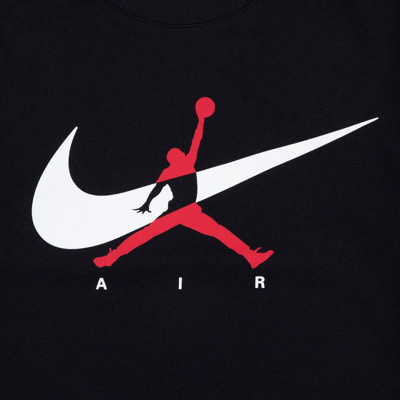 Black youth T-shirt close-up of white Nike swoosh and red Jumpman silhouette graphic