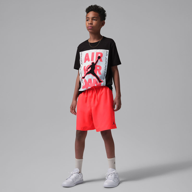 Youth Infrared red shorts with elastic waistband and drawstring, full-length side view
