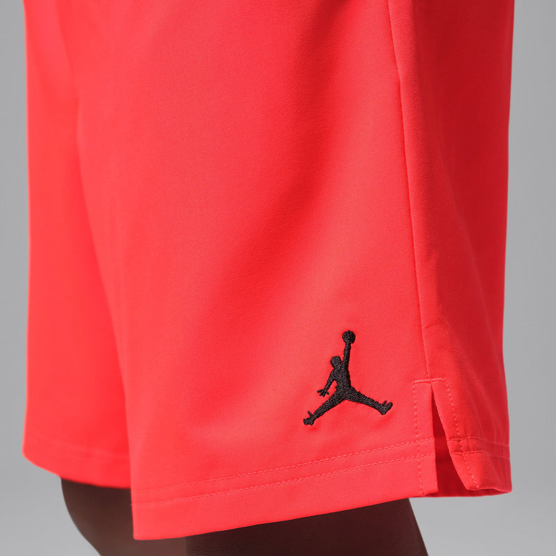 Infrared red short leg with black Jumpman logo near hem and stitched side slit