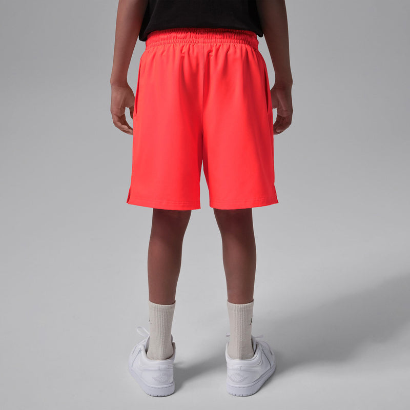 Youth Infrared red woven shorts back view with elastic waistband and hem side vents