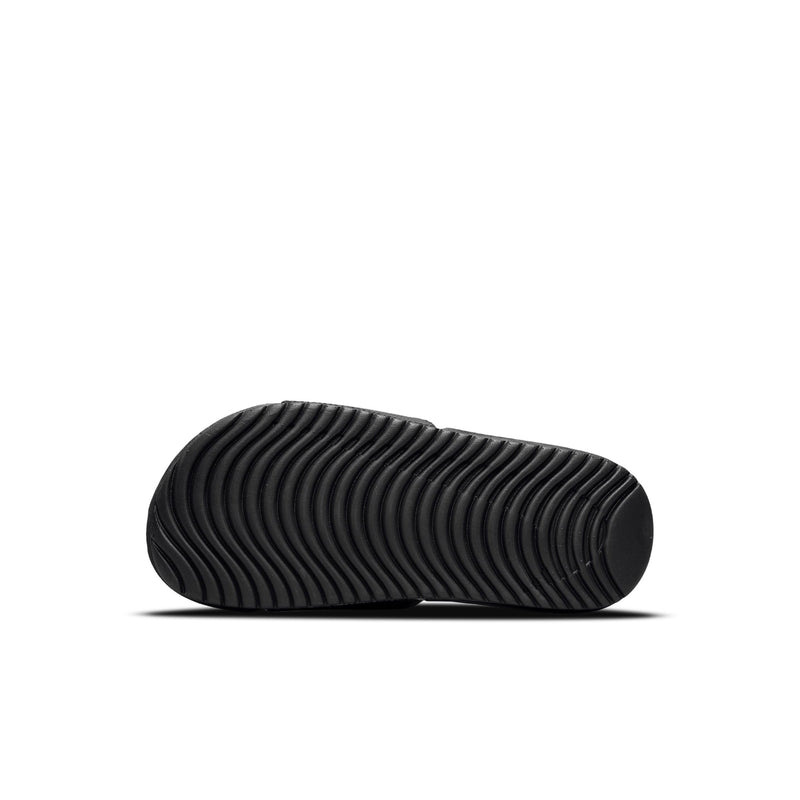 Kids black slide sandal sole view with ribbed tread and curved profile