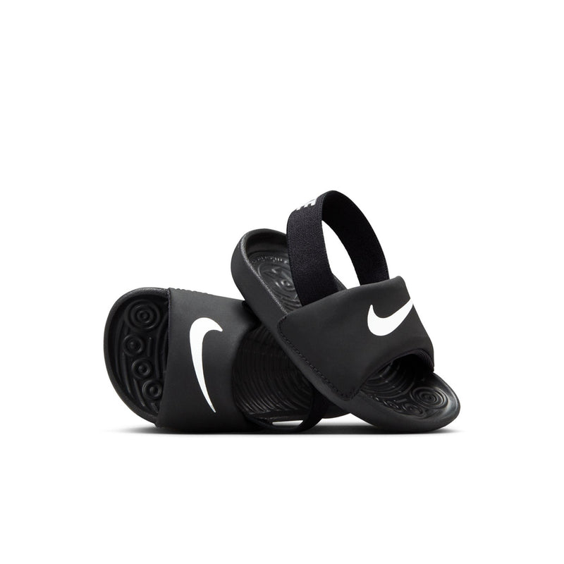 Toddler black slide sandals, side view, with white Swoosh and textured outsole