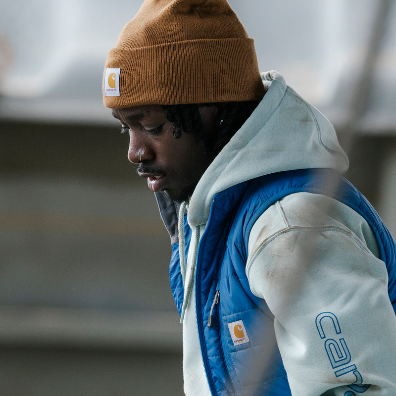 Carhartt brown cuffed knit beanie with small square Carhartt logo patch.