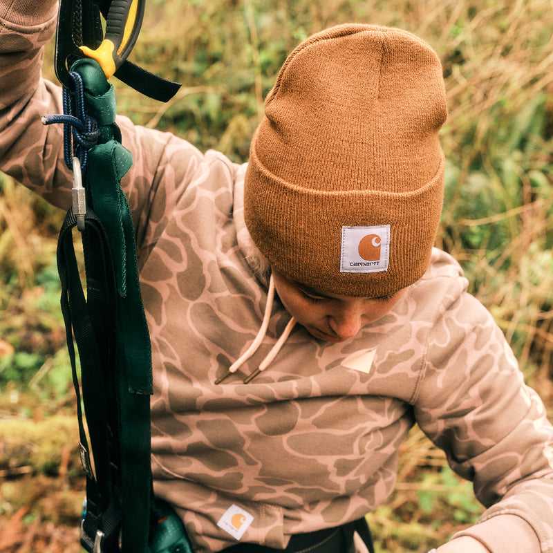 Carhartt brown knit beanie with folded cuff and square Carhartt logo patch.
