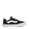 Kids black and white lace-up low-top skate sneakers with white side stripe.