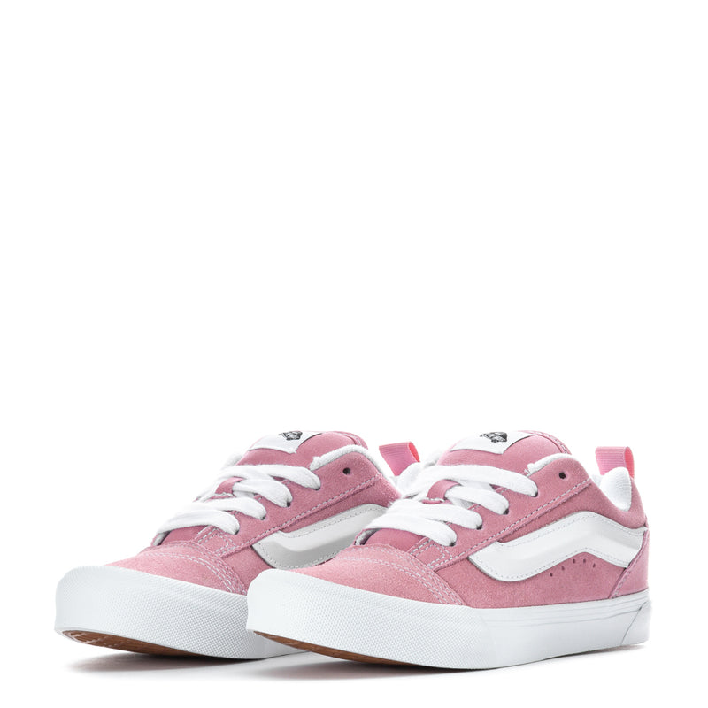 Pair of pink kids low-top sneakers with white laces and contrasting stripe panels