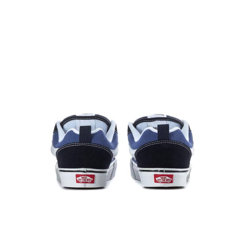 Men's navy and white low-top sneakers, back view with heel tabs and white soles.