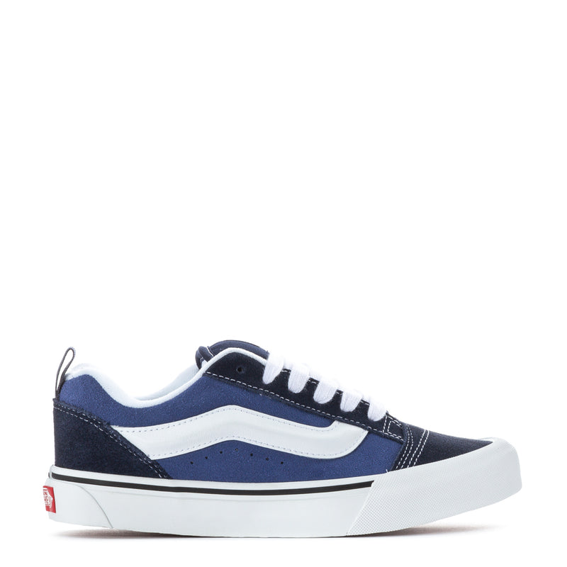 Youth navy-and-white sneakers with white laces and low-profile sole