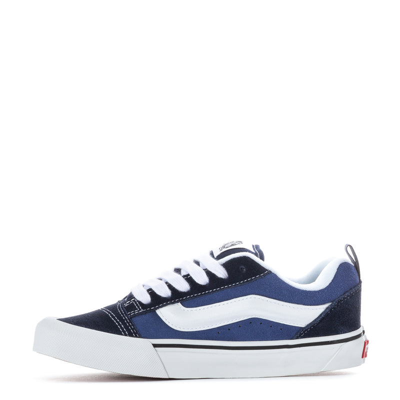 Youth low-top sneakers in navy and white, side view with lace-up design