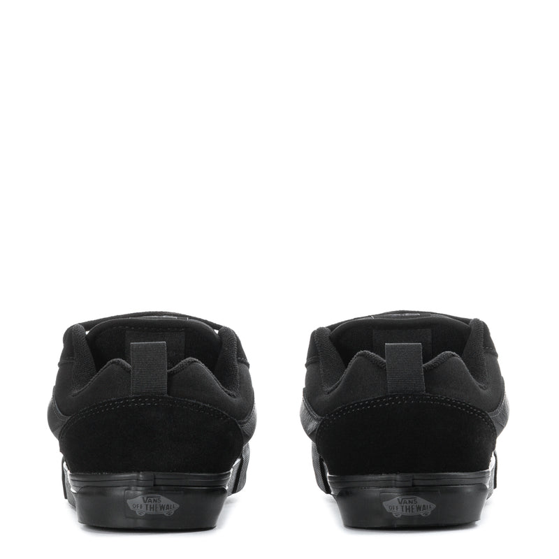 Youth black sneakers heel view, padded collar and rubber sole with rear label