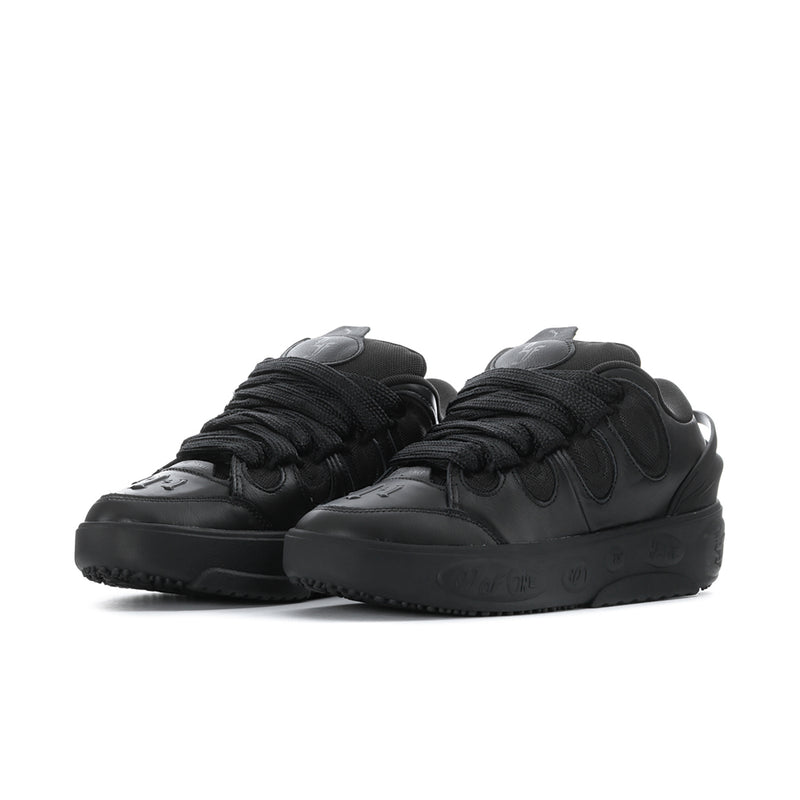 Black low-top sneakers side view with lace-up and stitched panel details