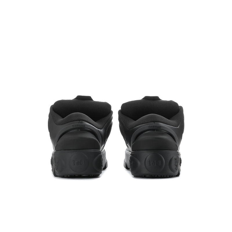 Black sneakers rear view with heel tab and molded sole tread