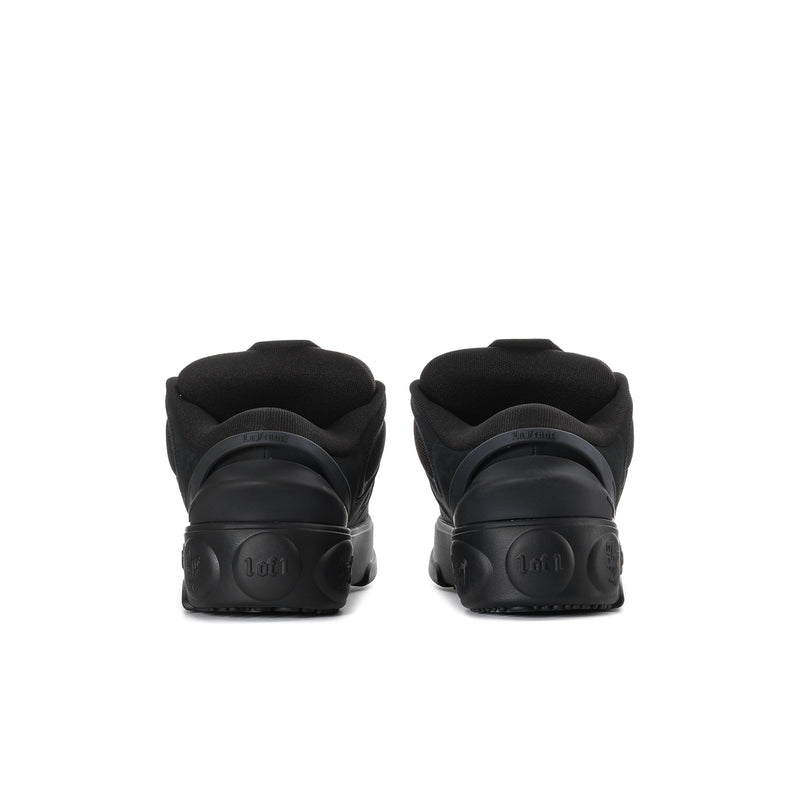 Black skate shoes, rear view with padded collar and grippy outsole tread