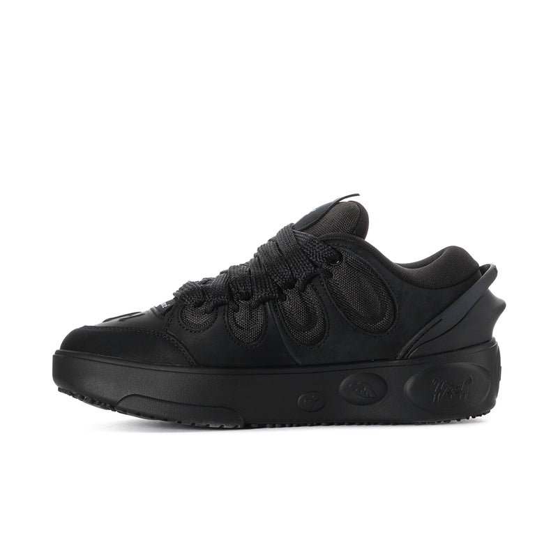 Black lace-up skate shoe with nubuck-like texture and side traction outsole
