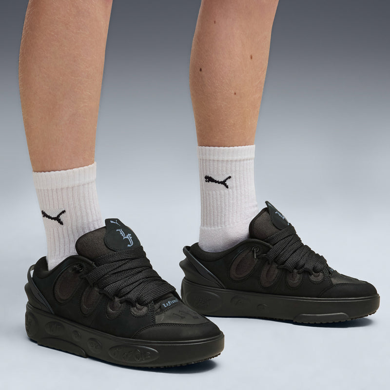 Black lace-up skate sneakers with side PUMA branding and chunky rubber outsole