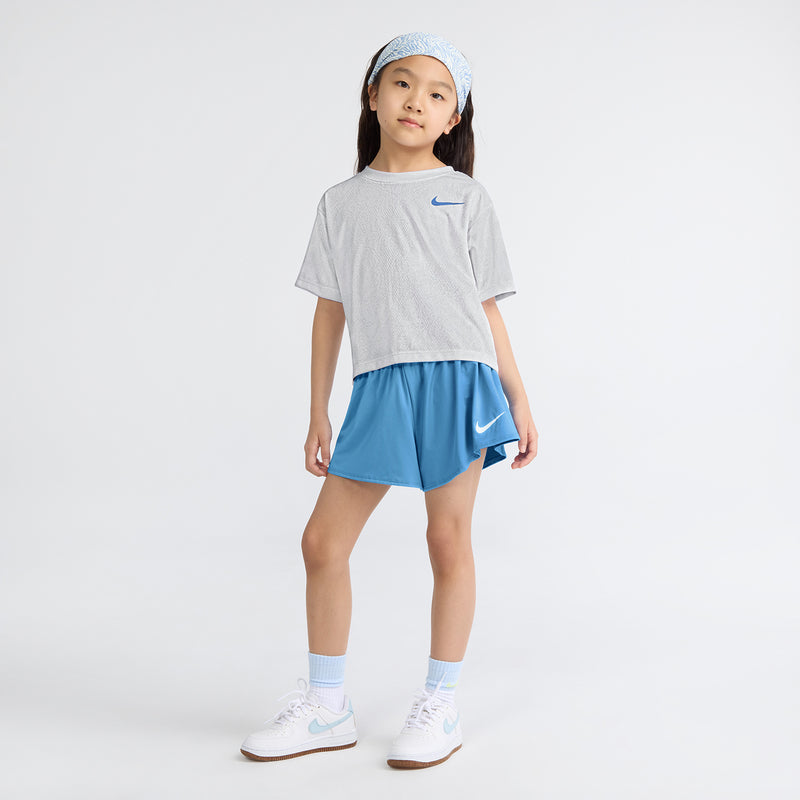 Kids gray T-shirt and blue athletic shorts set with swoosh logos, worn front view
