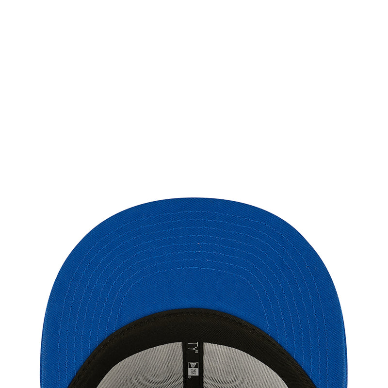 Blue baseball cap crown close-up with black inner band and gray label