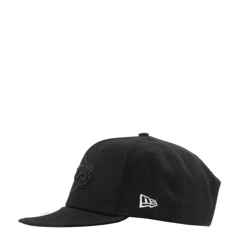 Black cap with New Era logo on side and curved brim